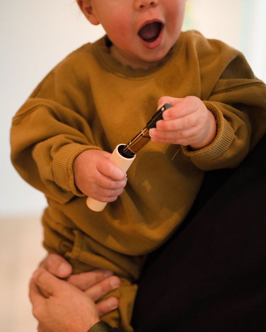 Young-child-holding-fenna-kids-vitamin-refills