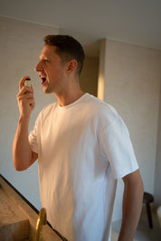 Man-in-bathroom-spraying-Fenna-Adult-AM-Vitamin-Spray