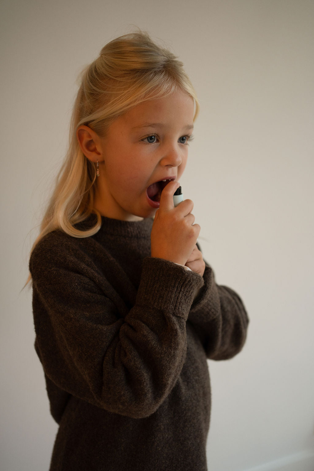 Young-girl-using-kids-pm-vitamin-spray