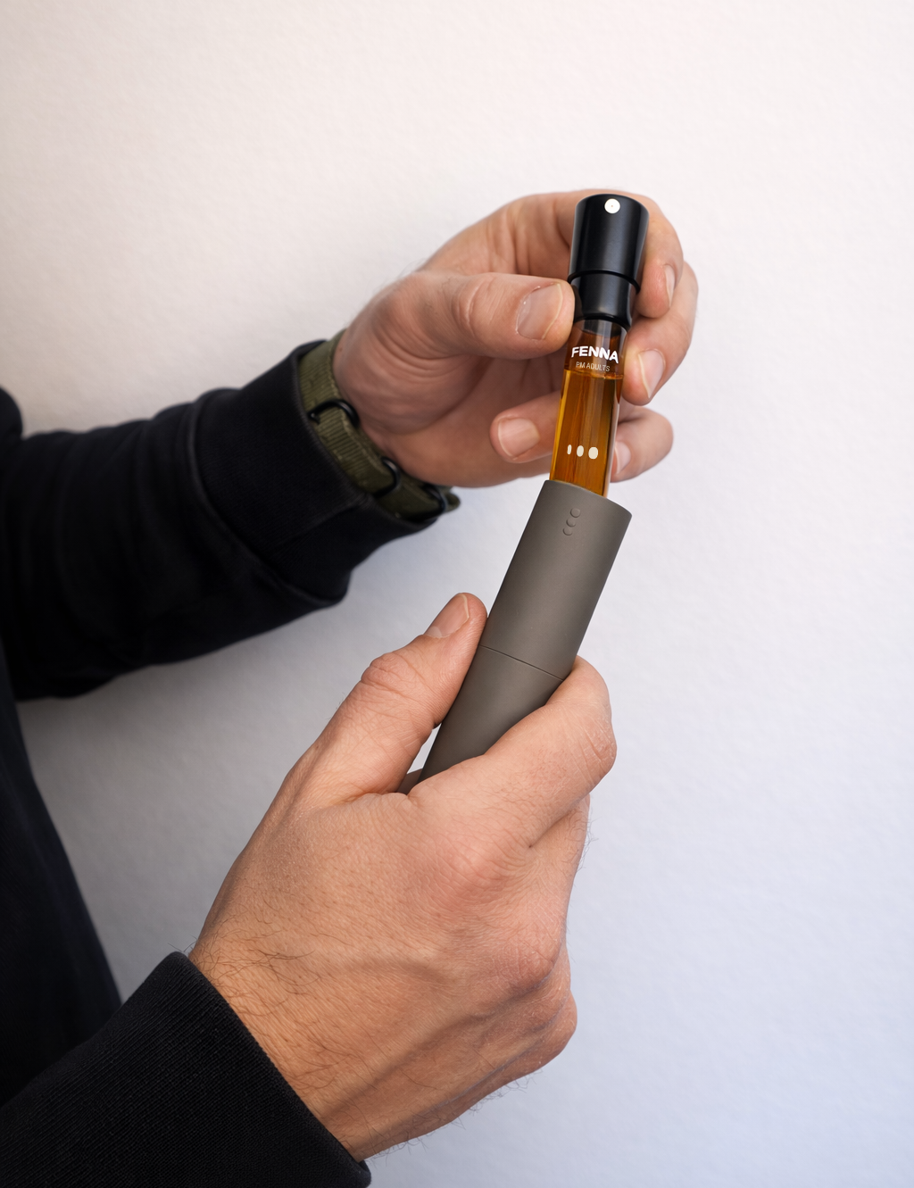 Man-holding-adult-vitamin-pm-spray-and-refill