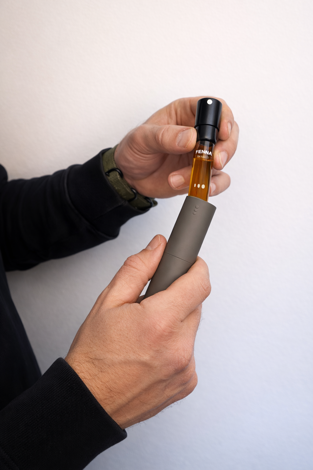 Man-holding-adult-vitamin-pm-spray-and-refill